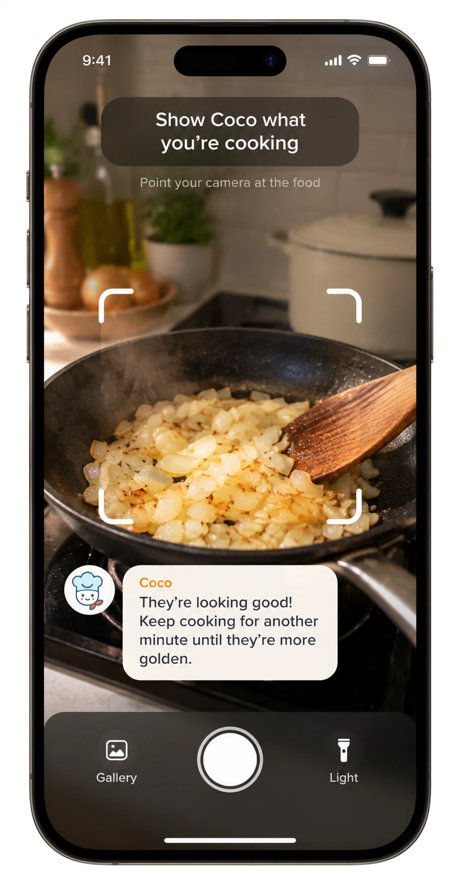 Coco's camera check: pointed at a pan of onions, telling the cook they're looking good and need another minute